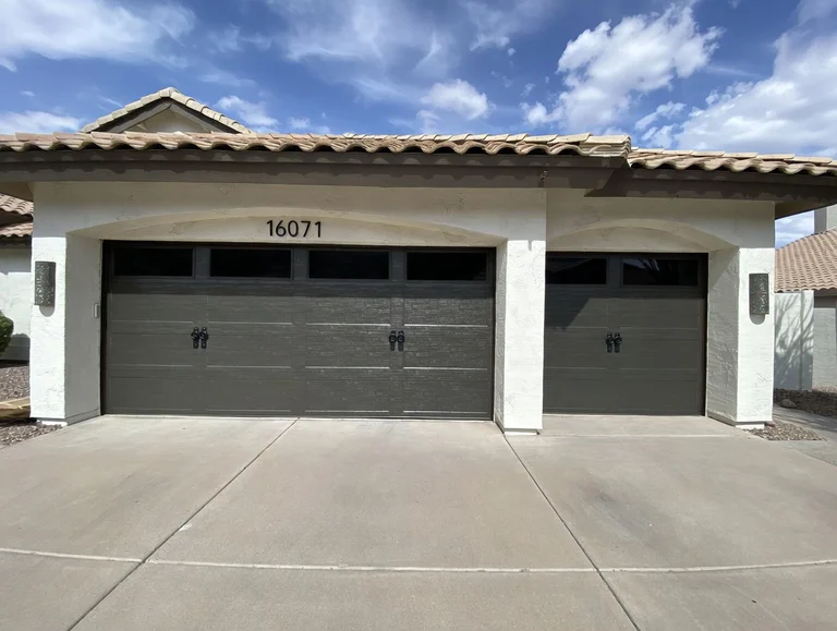 Grey Long Panel Garage Door With Tinted Glass And Accent Hardware